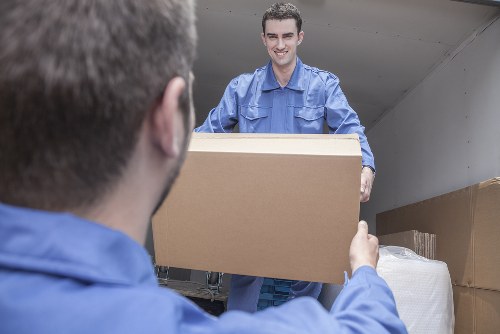 Moving van and crew preparing items safely for transport